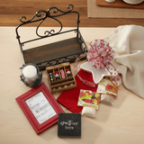 Collection of decorative items including a red frame, small wooden box, and candle on a wooden surface.