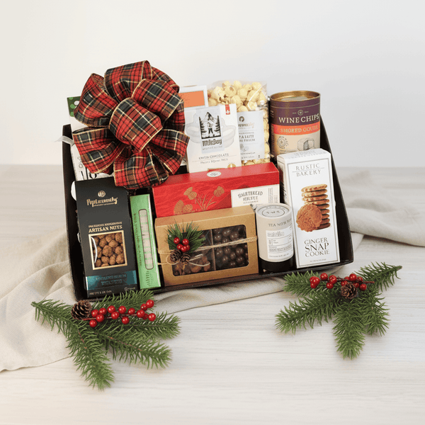 SANTA'S SNACKS GIFT TRAY featuring gourmet snacks in a festive basket, including cookies, popcorn, chocolates, and more, elegantly wrapped with a bow.