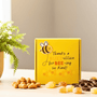 a yellow bee themed gift box that says "thanks a buzz-illion for bee-ing so kind!" on the front with a happy bee